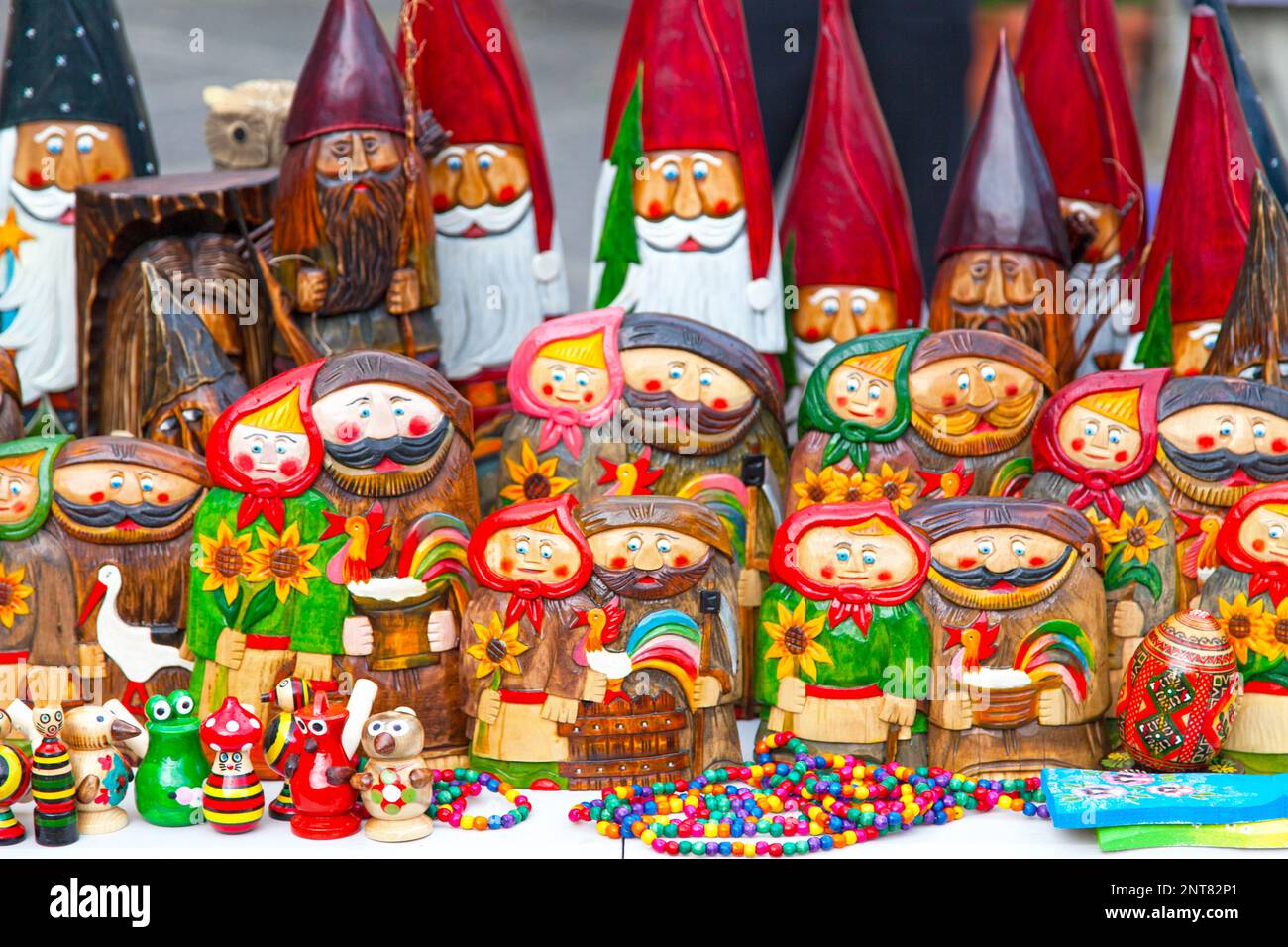 Wooden gnomes for sale on a market stall in old town Warsaw in Poland. Stock Photo