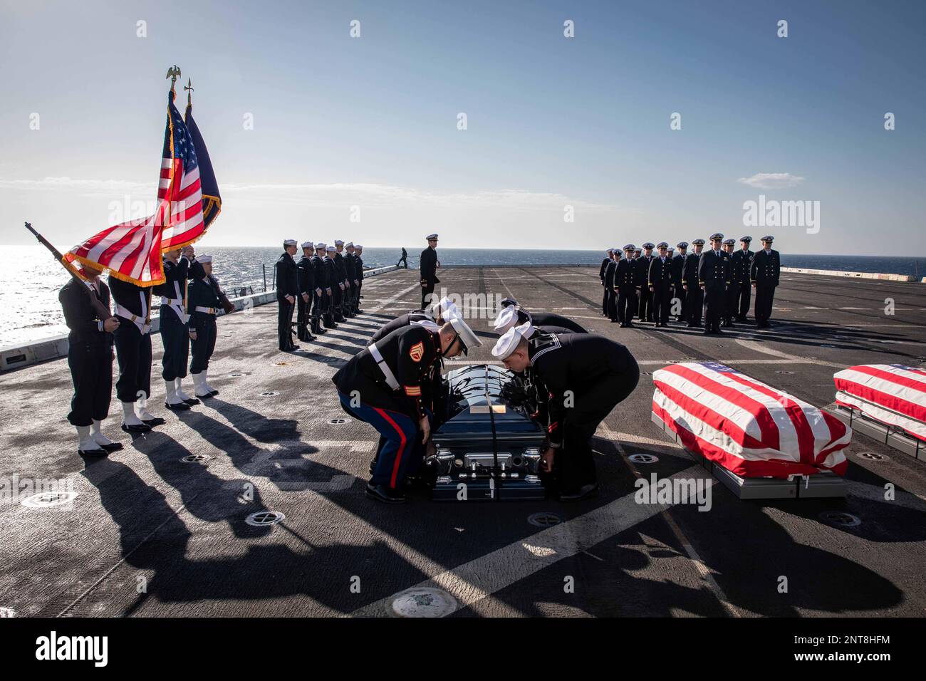 Atlantic Ocean. 24th Feb, 2023. Sailors and a U.S. Marine assigned to the San Antonio-class amphibious transport dock ship USS Arlington (LPD 24) lift a casket during a burial-at-sea in the Atlantic Ocean, February. 24, 2023. USS Arlington committed 20 cremated remains and 7 casketed remains to the sea. Credit: U.S. Navy/ZUMA Press Wire Service/ZUMAPRESS.com/Alamy Live News Stock Photo