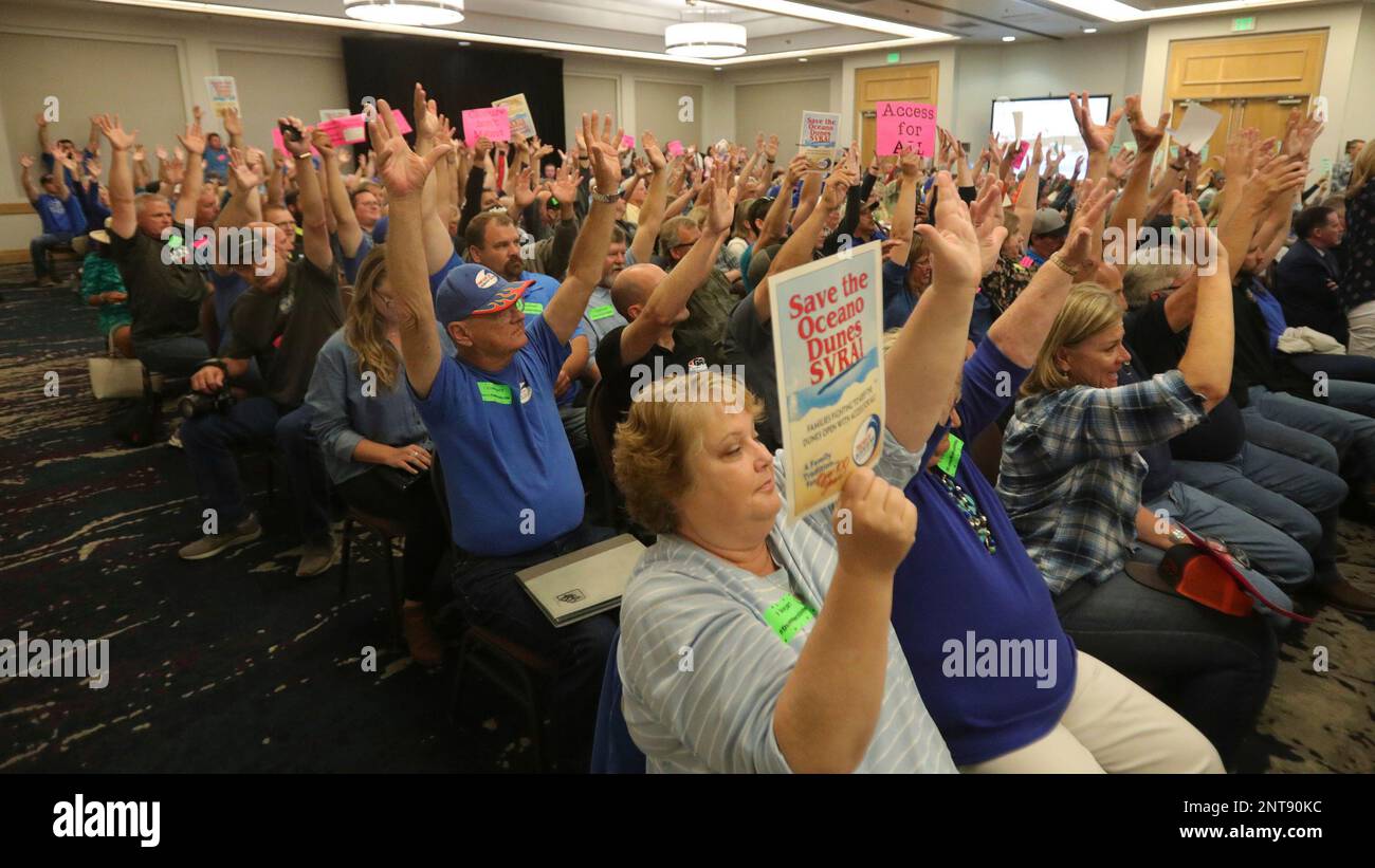 Pro dune riding community waves their hands in support of a point at a