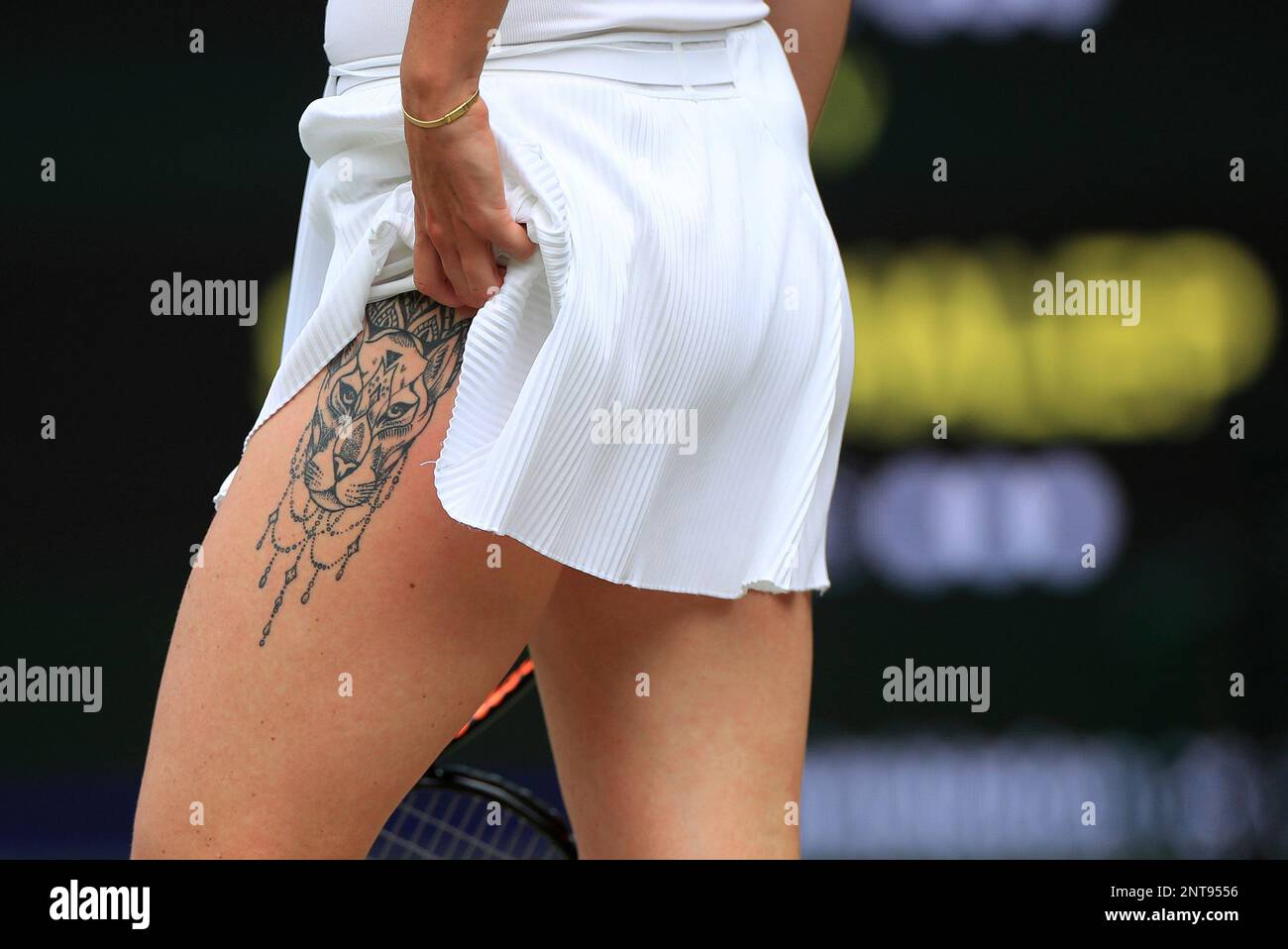 A close-up of the tattoo on the leg of Ukraine's Elina Svitolina as she  prepares to serve to Romania's Simona Halep in a Women's semifinal singles  match on day ten of the, image size:1300x958