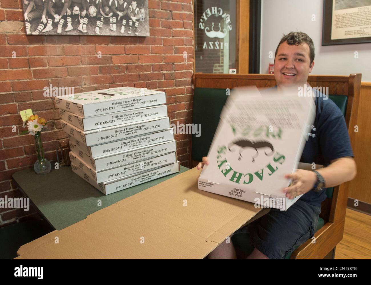 Andrew Chartier, 19, folds pizza boxes at Stachey's in North Andover, Mass. Andrew finished