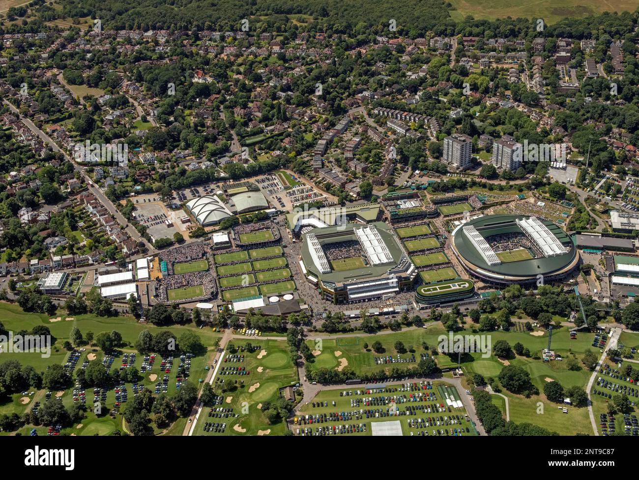 An aerial view of All England Tennis Club, bottom left, during day ...