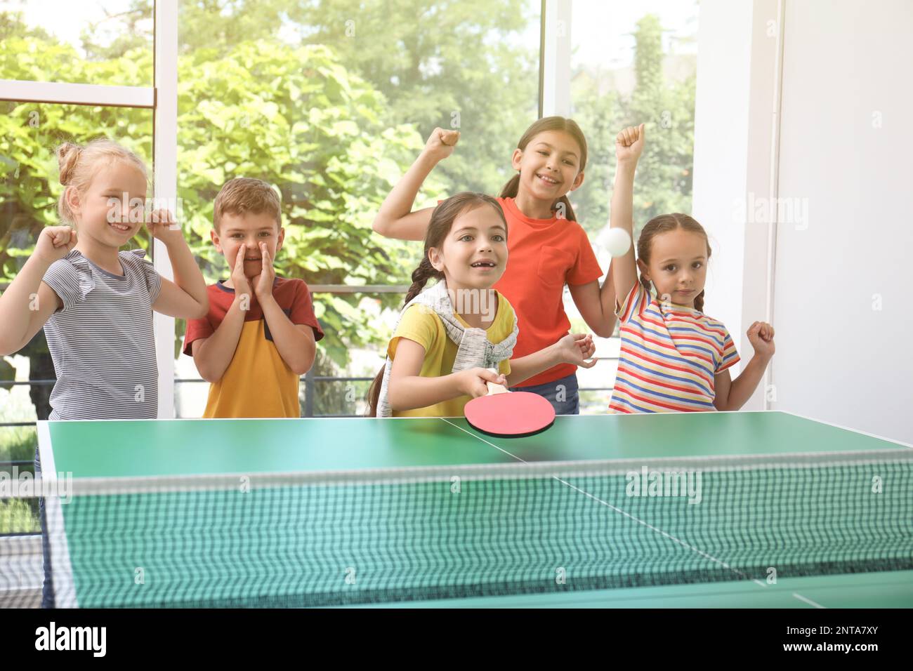 Cute happy children playing ping pong indoors Stock Photo Alamy