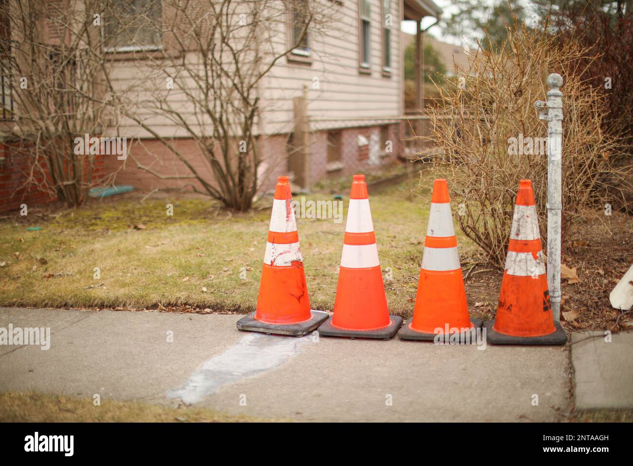 Construction cone in the street sidewalk showing caution during traffic Stock Photo