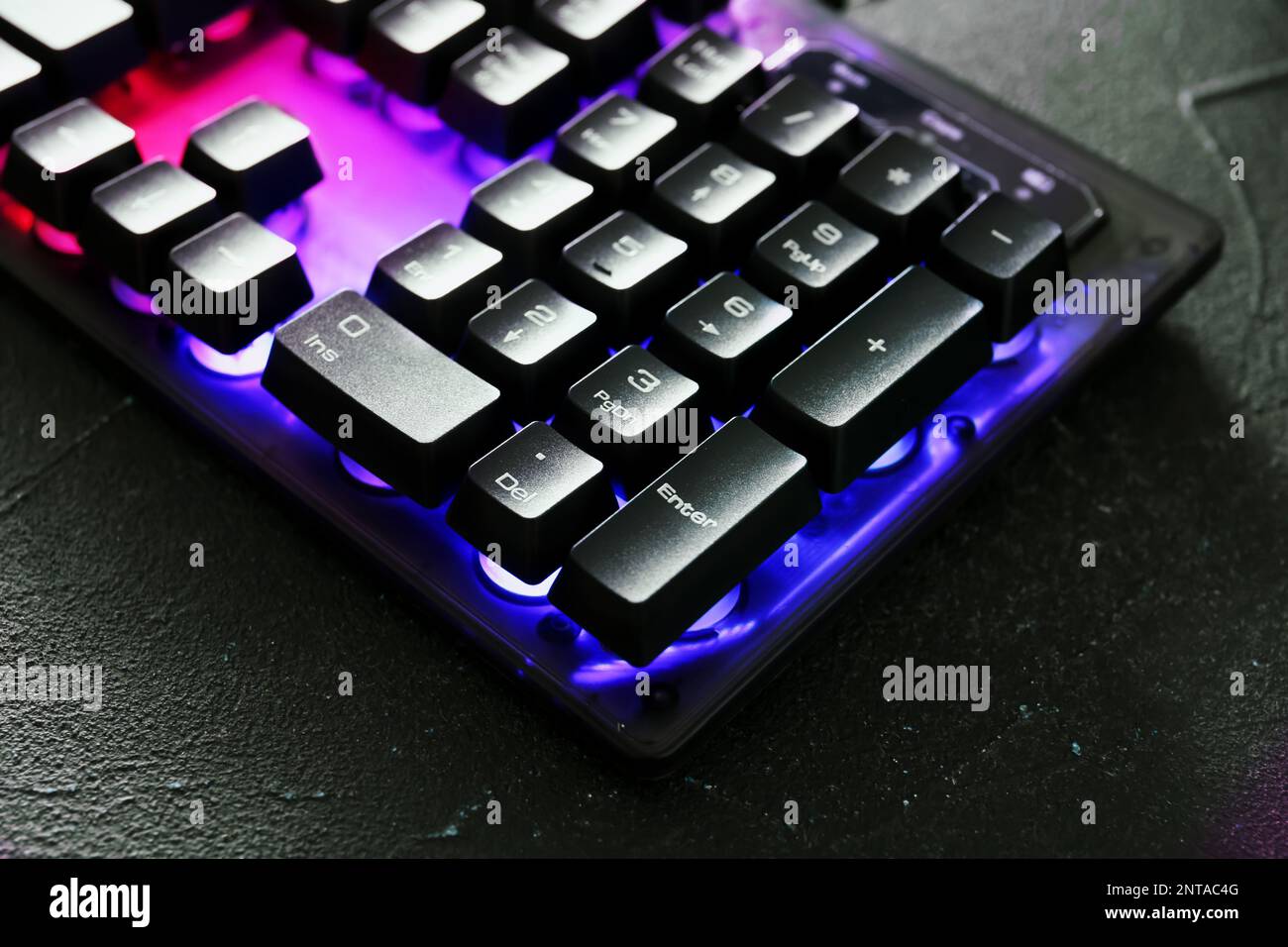 Modern keyboard with RGB lighting on grey table, closeup Stock Photo