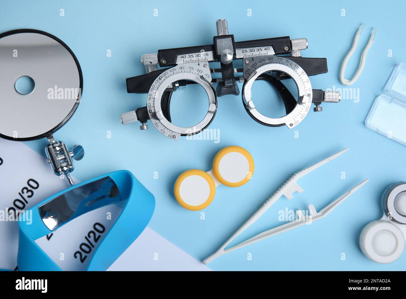 Different ophthalmologist tools on light blue background, flat lay Stock Photo Alamy
