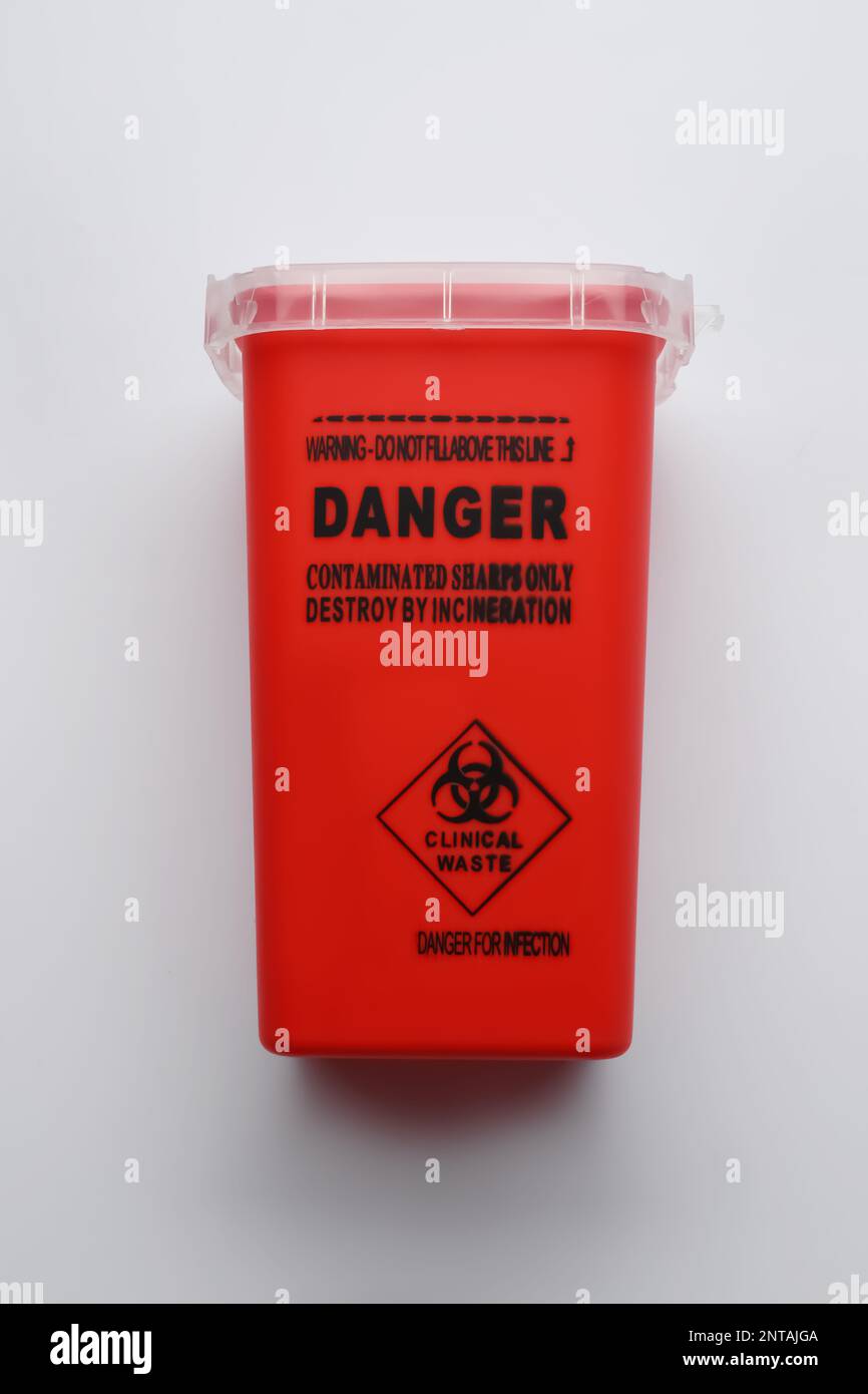 Sharps container for used syringe on white background, top view Stock