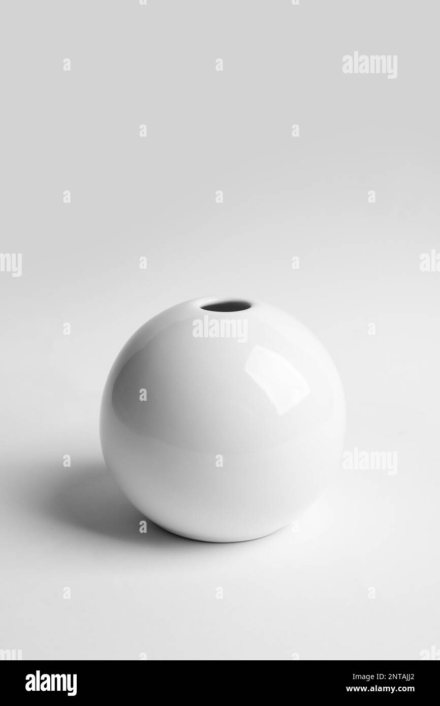 Stylish white ceramic vase on light background Stock Photo