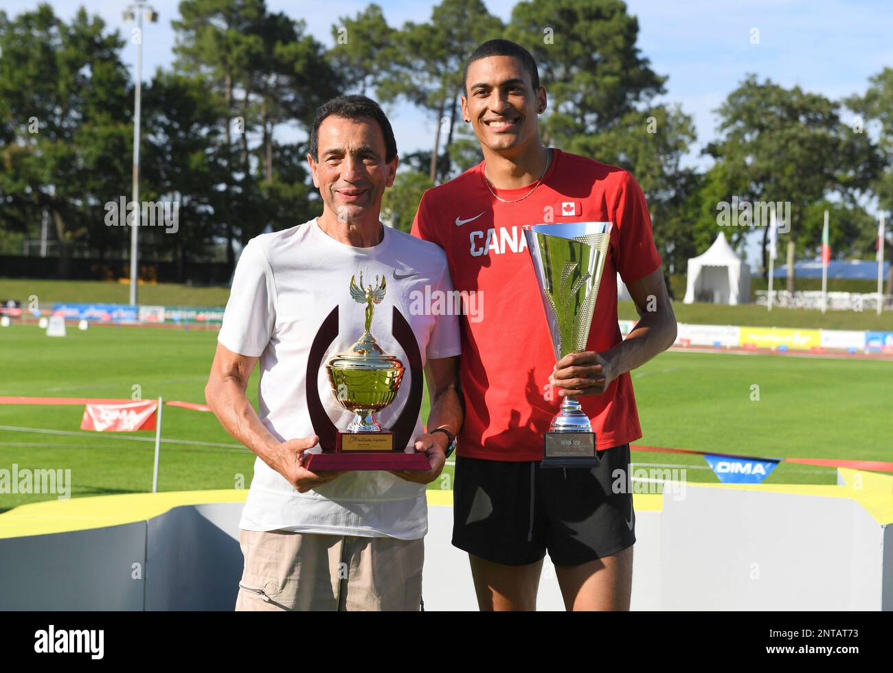 Pierce LePage (CAN), right, poses with trophy and coach Gregory Portnoy  after winning the decathlon with 8,453 points during the decathlon at the  DecaStar meeting, Saturday, June 23, 2019, in Talence, France. (
