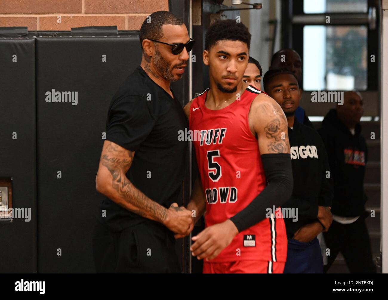 Tuff Crowd Power Forward Kenyon Martin Jr. (5) (right) hugs his father