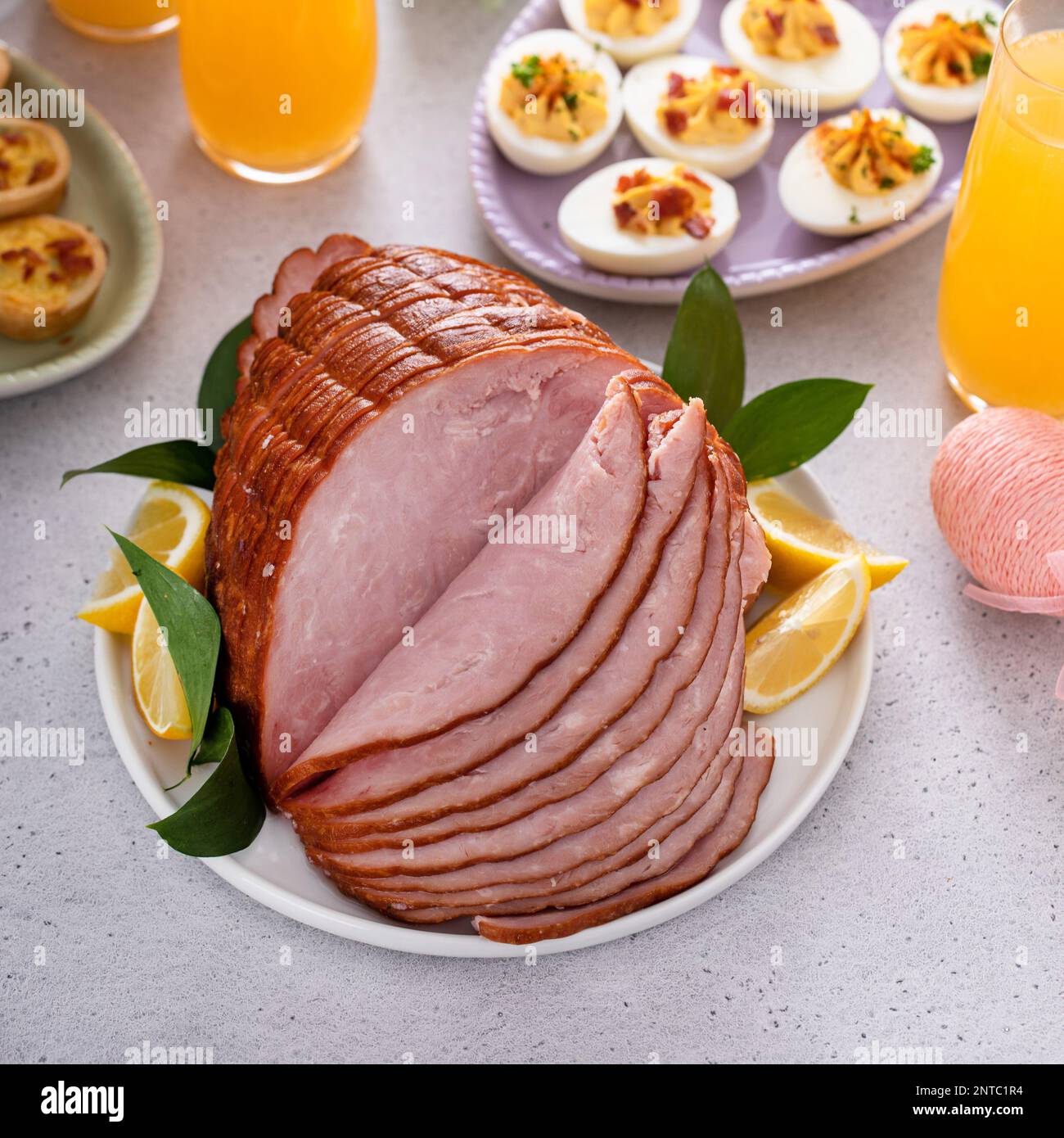 Traditional Easter ham on the table served with Easter brunch Stock Photo