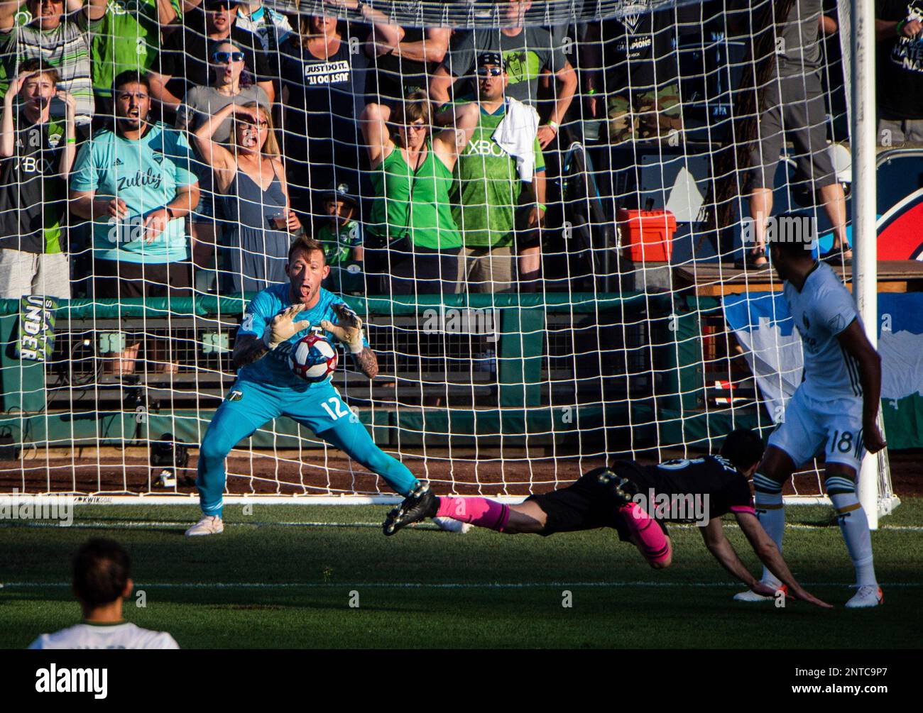 Portland Timbers goalkeeper Steve Clark (12) blocks a shot by Seattle