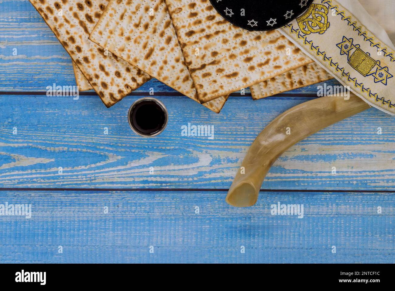 For Pesach unleavened matzah bread is eaten and kosher kiddush cup wine is used to celebrate holiday. Stock Photo