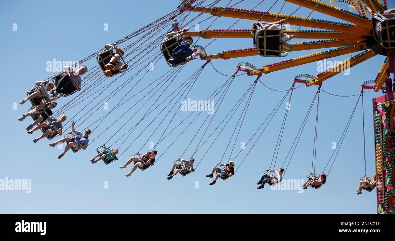 Visitors swing high on a ride at the annual Dalton Carnival at the