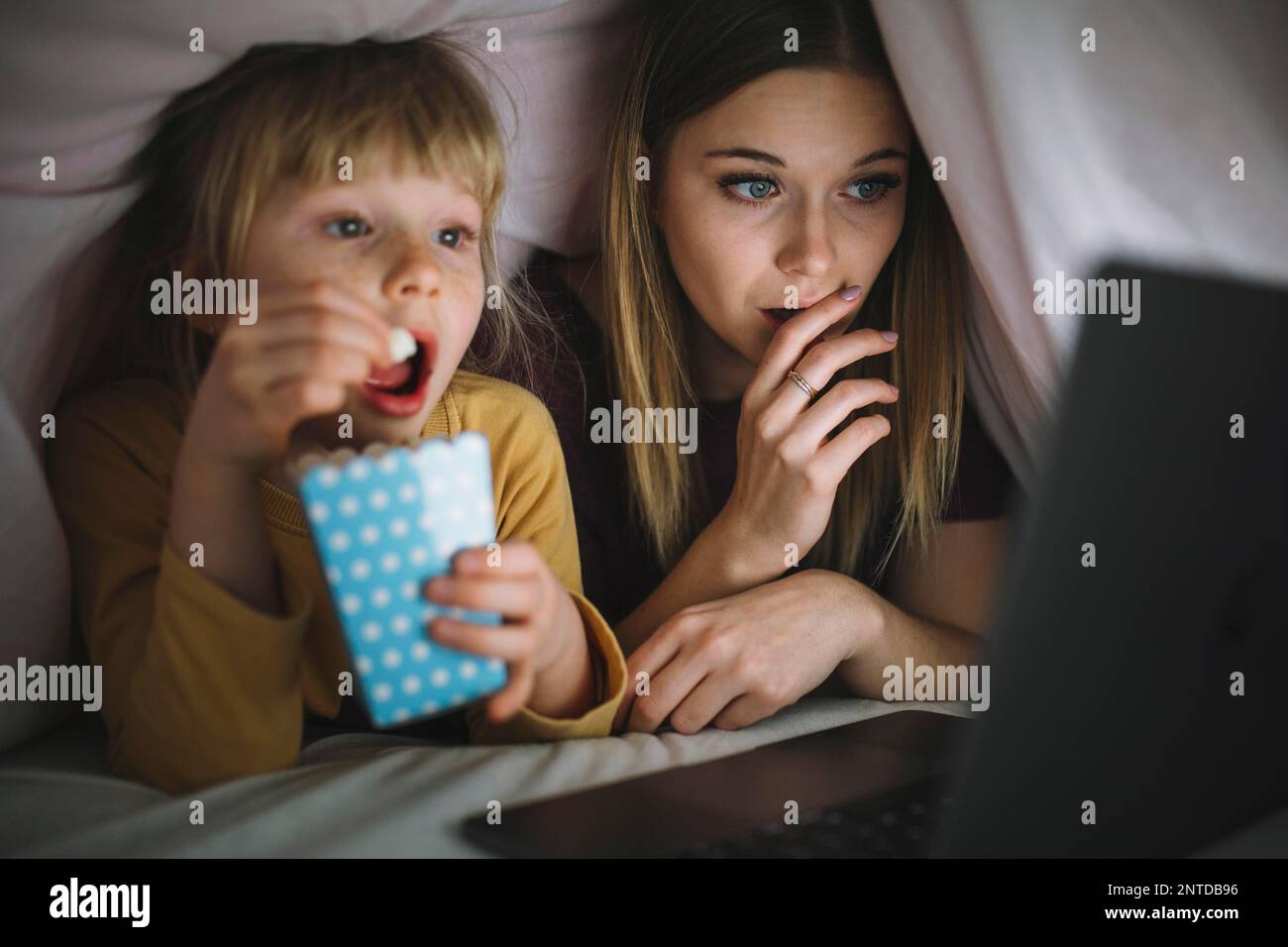 Sisters watching interesting film Stock Photo