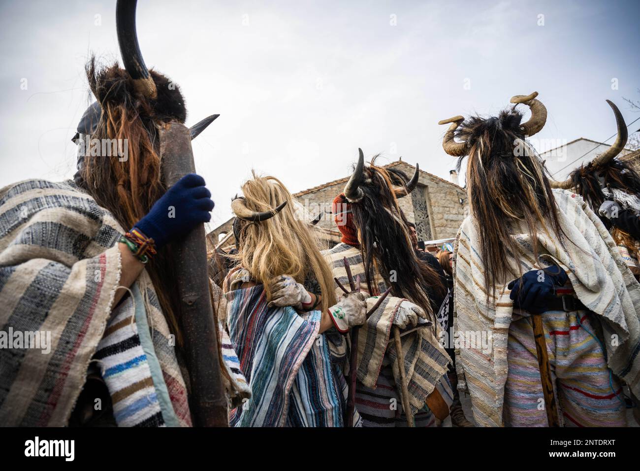 Navalosa, Spain. 19th Feb, 2023. Revelers dressed as Cucurrumachos seen during the Carnival celebration in Navalosa. In the village of Navalosa, men and women take to the streets dressed in striped blankets traditional to the region and masks covered in animal hair. Much of the disguise includes bones, horns and skulls, in a ritual of Celtic origin that chronology does not know for sure when it started. These figures, half man, half beast, are the Cucurrumachos of Navalosa. (Credit Image: © Hugo Amaral/SOPA Images via ZUMA Press Wire) EDITORIAL USAGE ONLY! Not for Commercial USAGE! Stock Photo