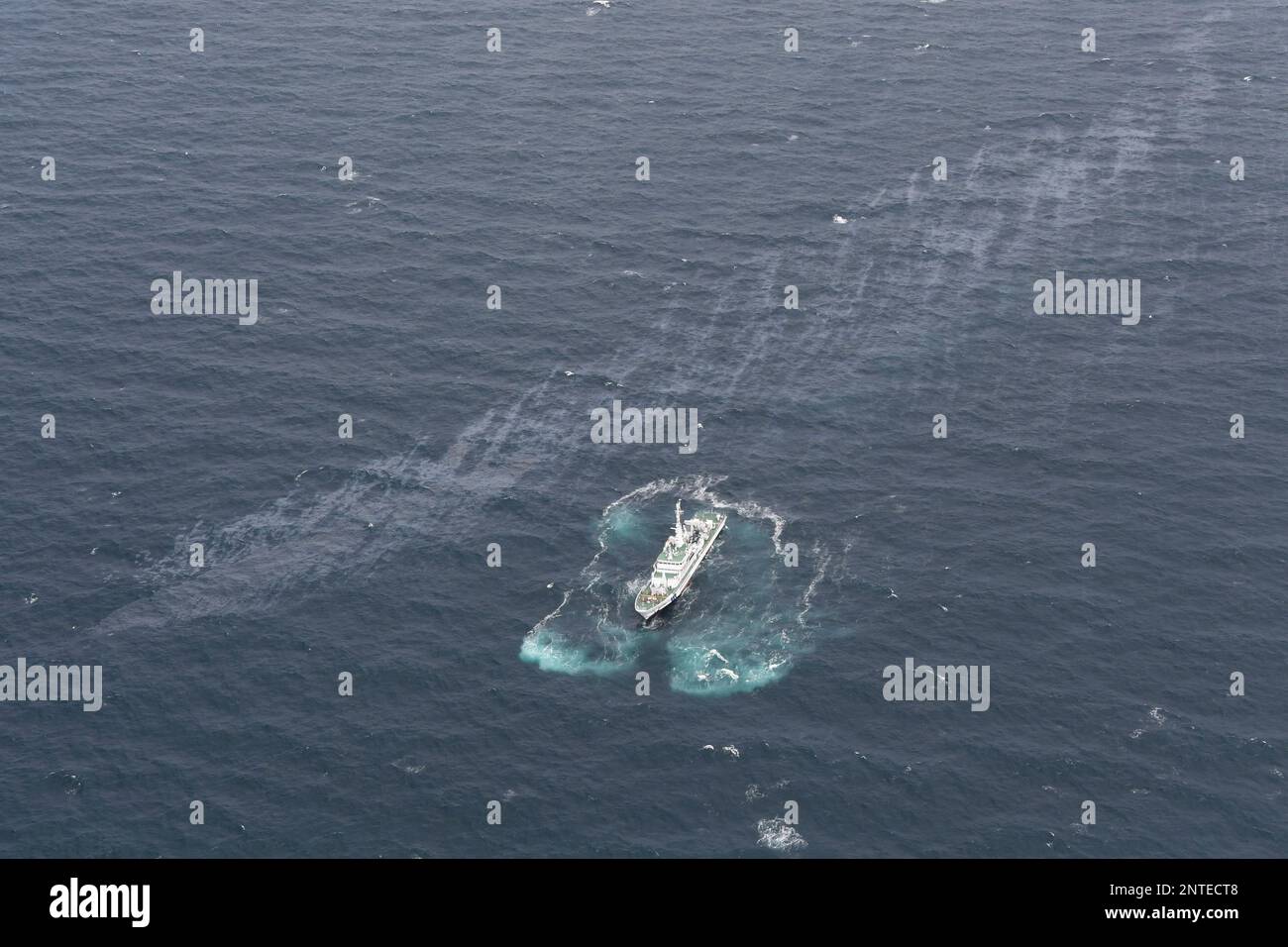 An aerial photo shows a patrol boat of the Japan Coast Guard searching