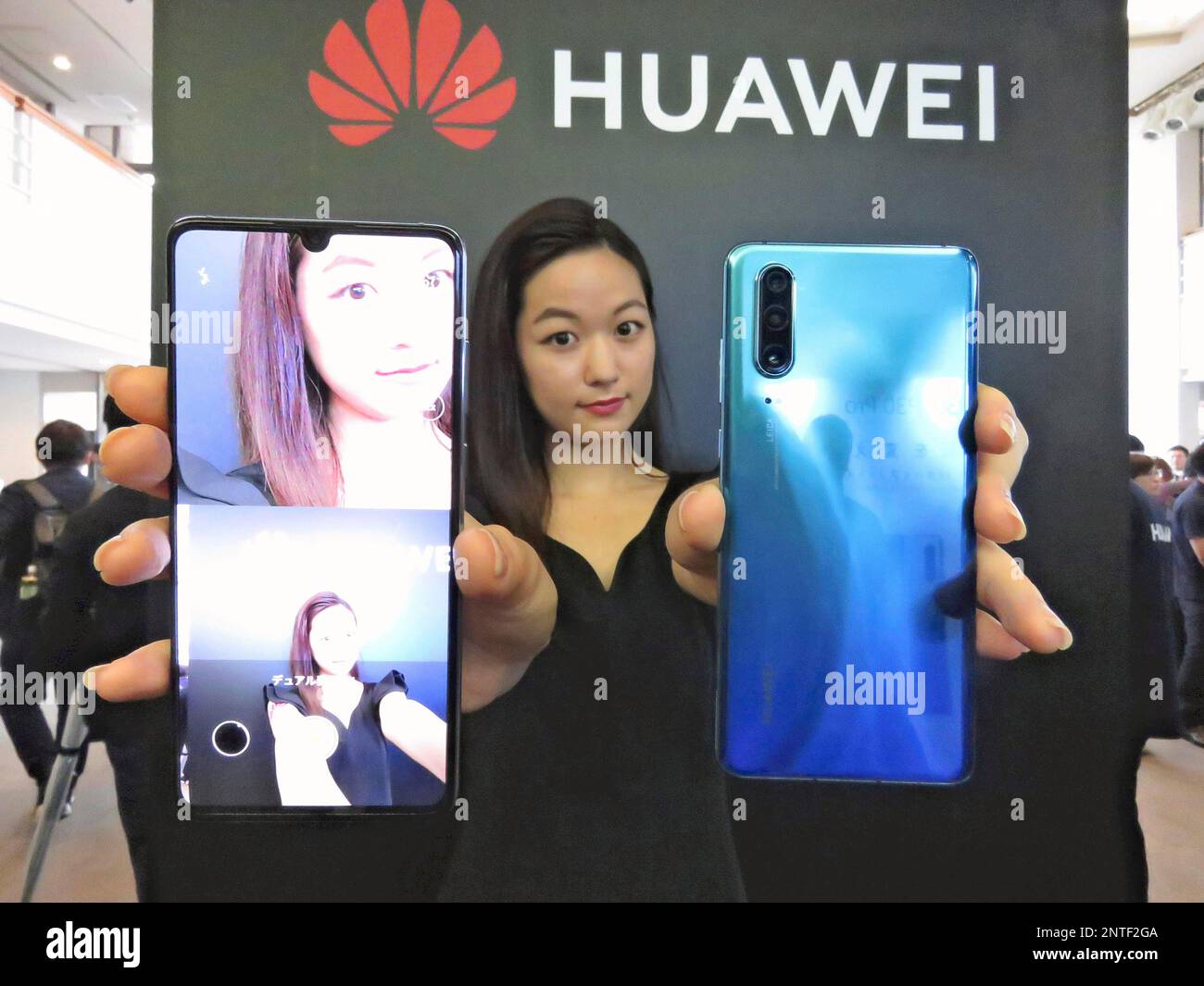 A model shows Huawei's new smartphoness in Meguro Ward, Tokyo on May 21,  2019. Japanese mobile carriers, KDDI and SoftBank Corp. announced that they  will delay releasing new smartphnes made by Huawei,