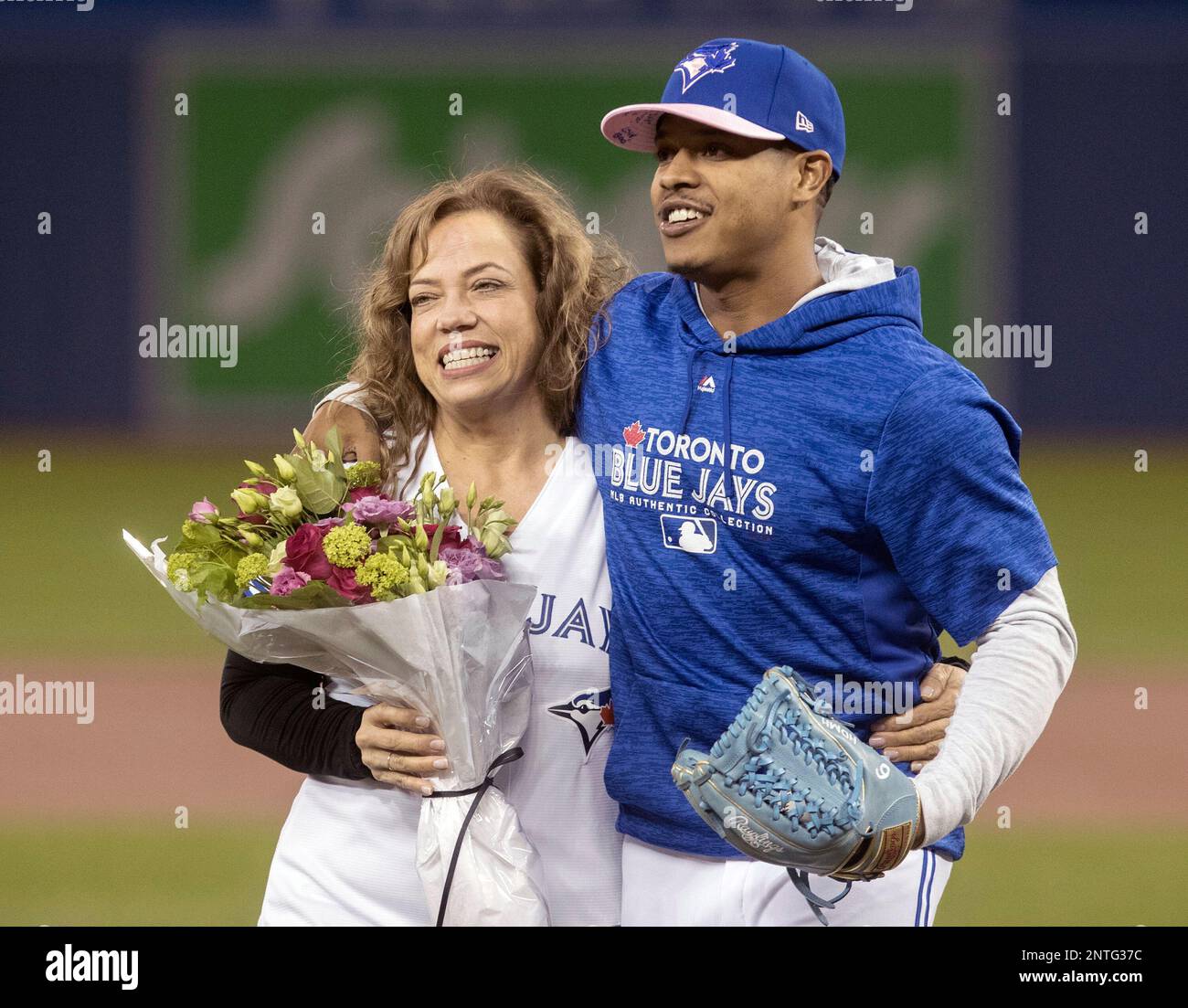 Toronto Blue Jays pitcher Marcus Stroman, right, hugs his mother Adlin  Auffant before she threw the ceremonial first pitch prior to a baseball  game against the Chicago White Sox in Toronto, Sunday