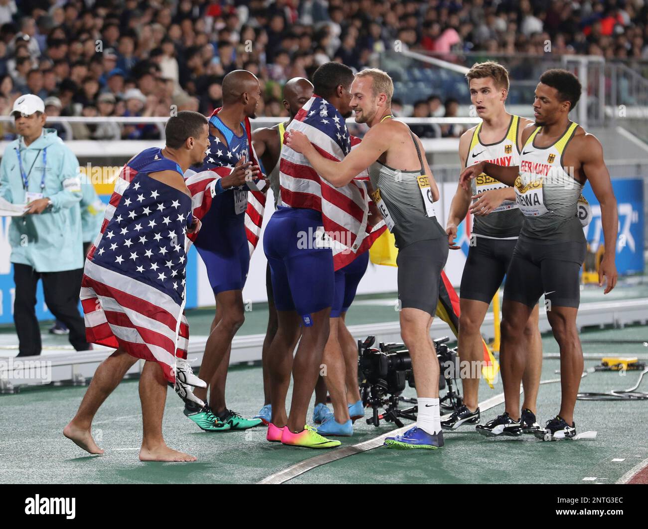 U.S. and German runners celebrate after the 4x200 Metres Relay Men