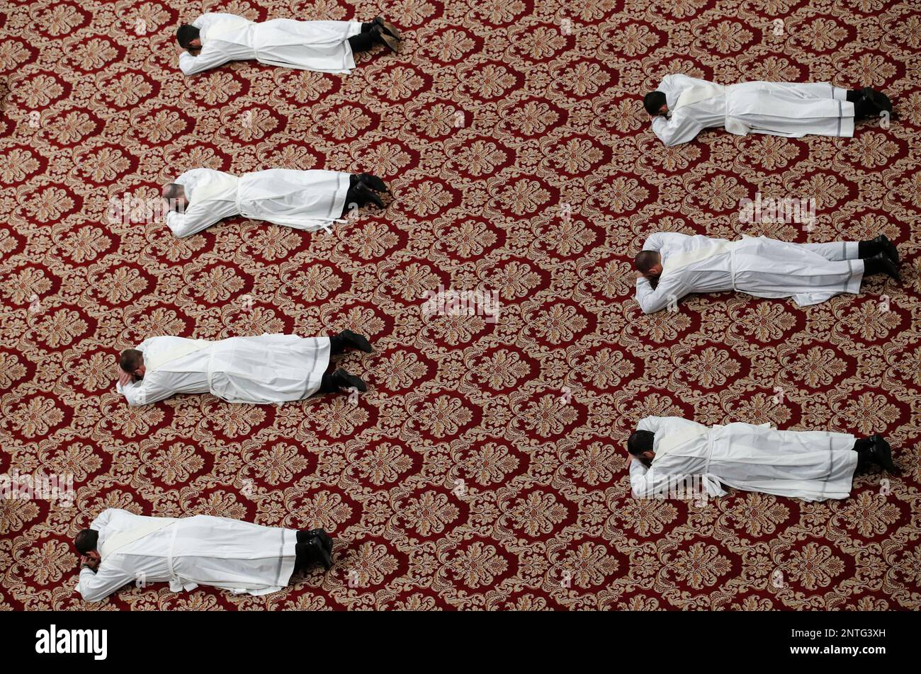 Priests lie face down on the floor during an ordination ceremony presided over by Pope Francis