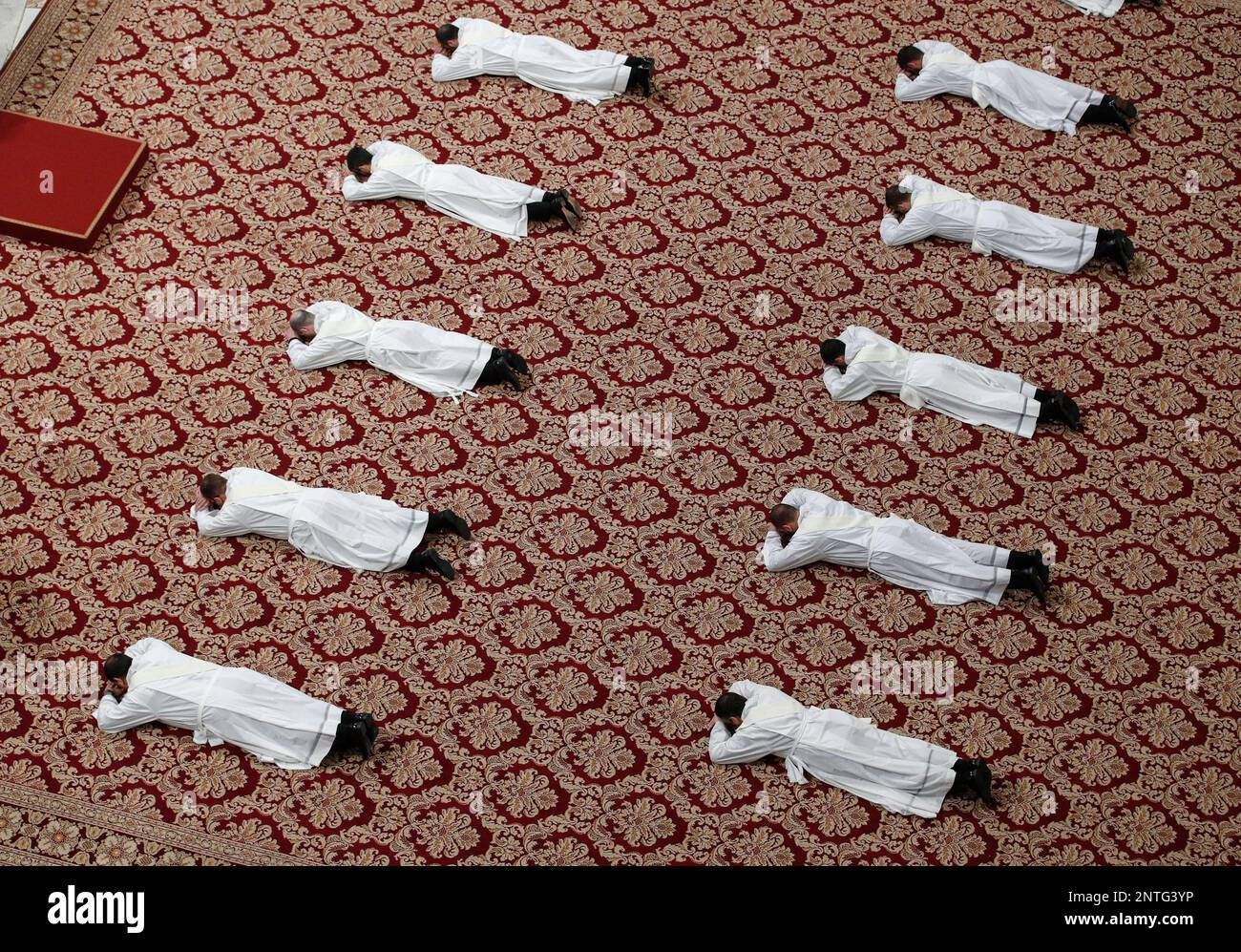 Priests lie face down on the floor during an ordination ceremony presided over by Pope Francis