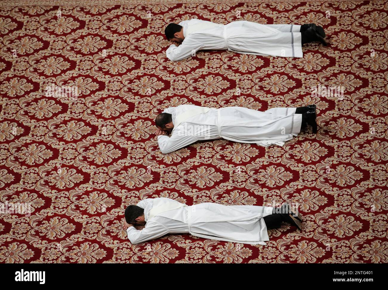 Priests lie face down on the floor during an ordination ceremony presided over by Pope Francis