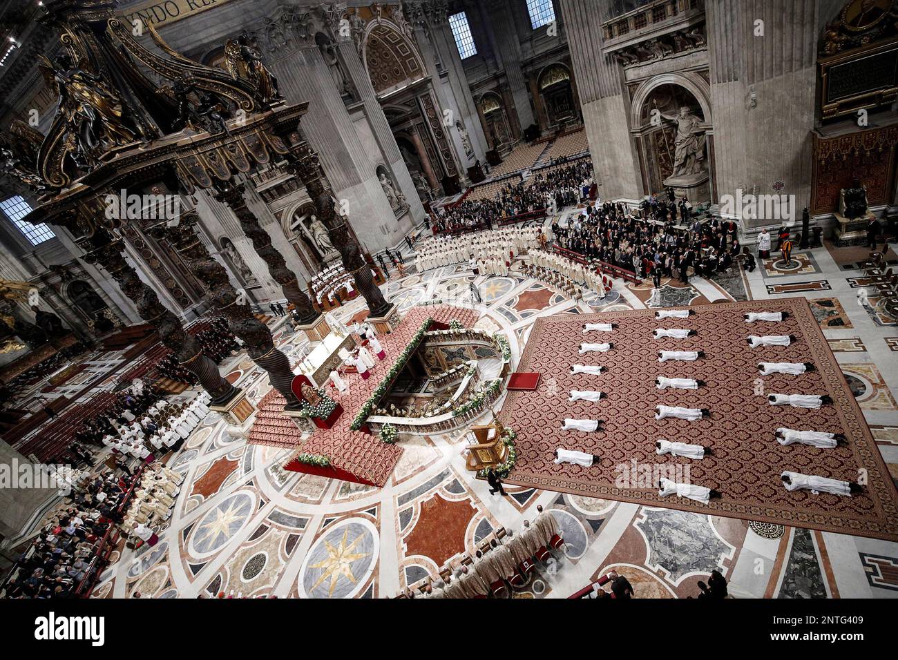 Priests lie face down on the floor during an ordination ceremony presided over by Pope Francis