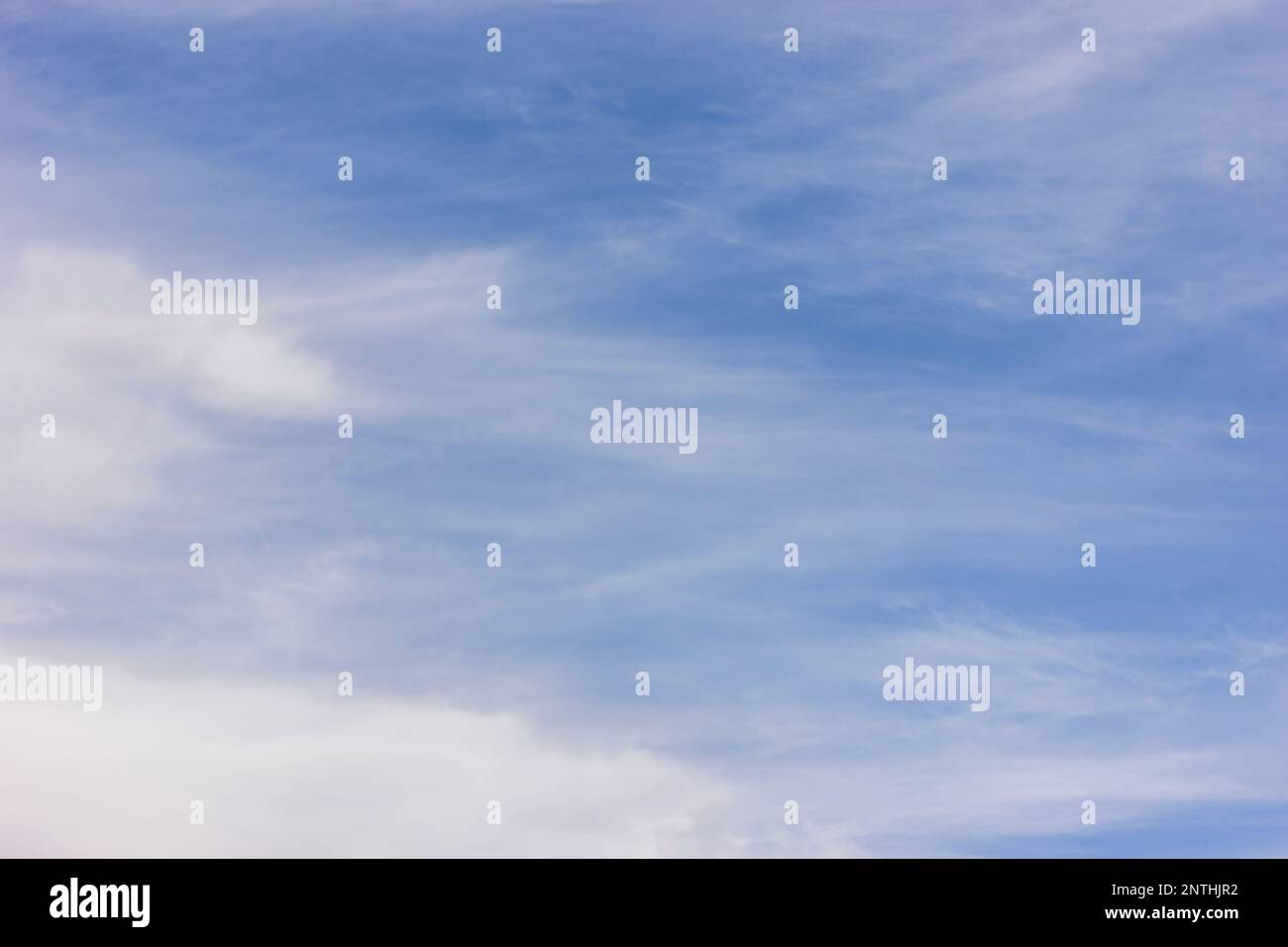 Blue sky with some white clouds for a background sky or wall paper or image replacement Stock Photo