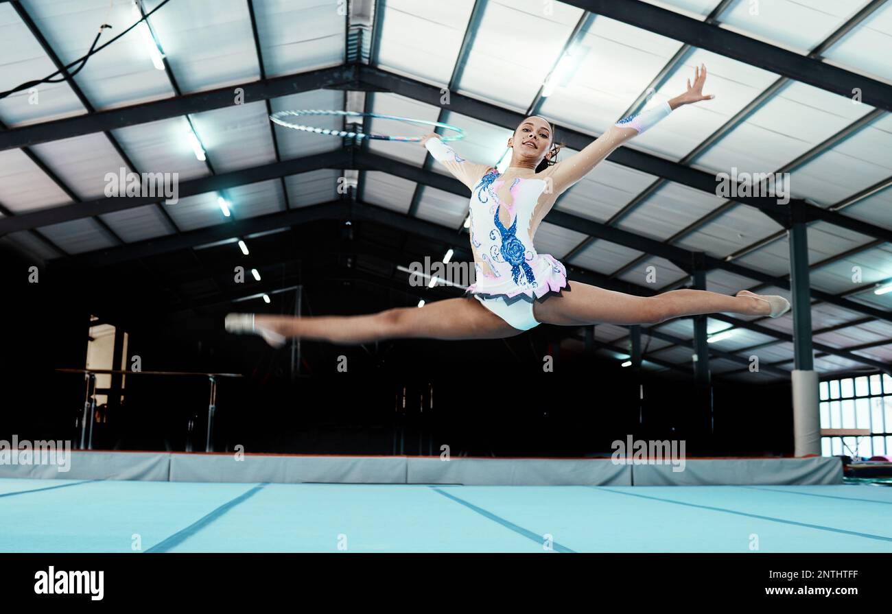 Gymnastics, woman athlete and performance at gym, fitness and leap