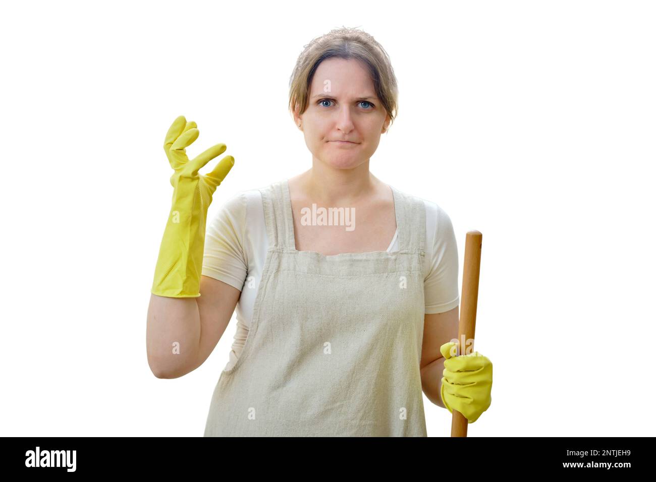 Angry woman glares at the camera while cleaning in the home kitchen, isolated on a white background Stock Photo