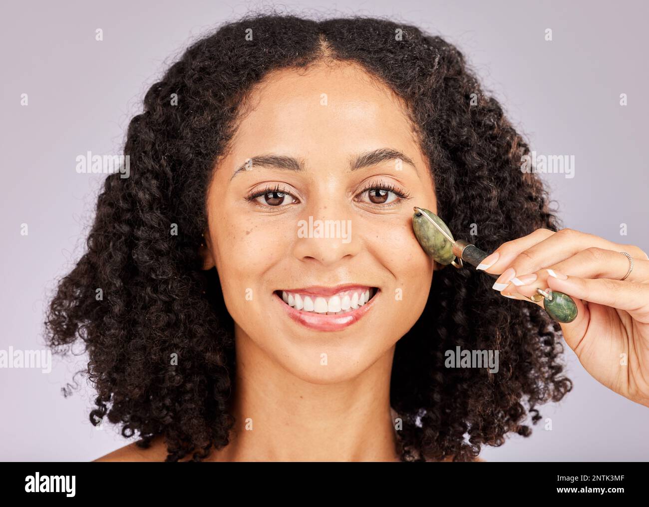 Jade facial roller, portrait and face skin glow of a black woman with beauty  stone tool in studio. Wellness, dermatology and young model with spa Stock  Photo - Alamy