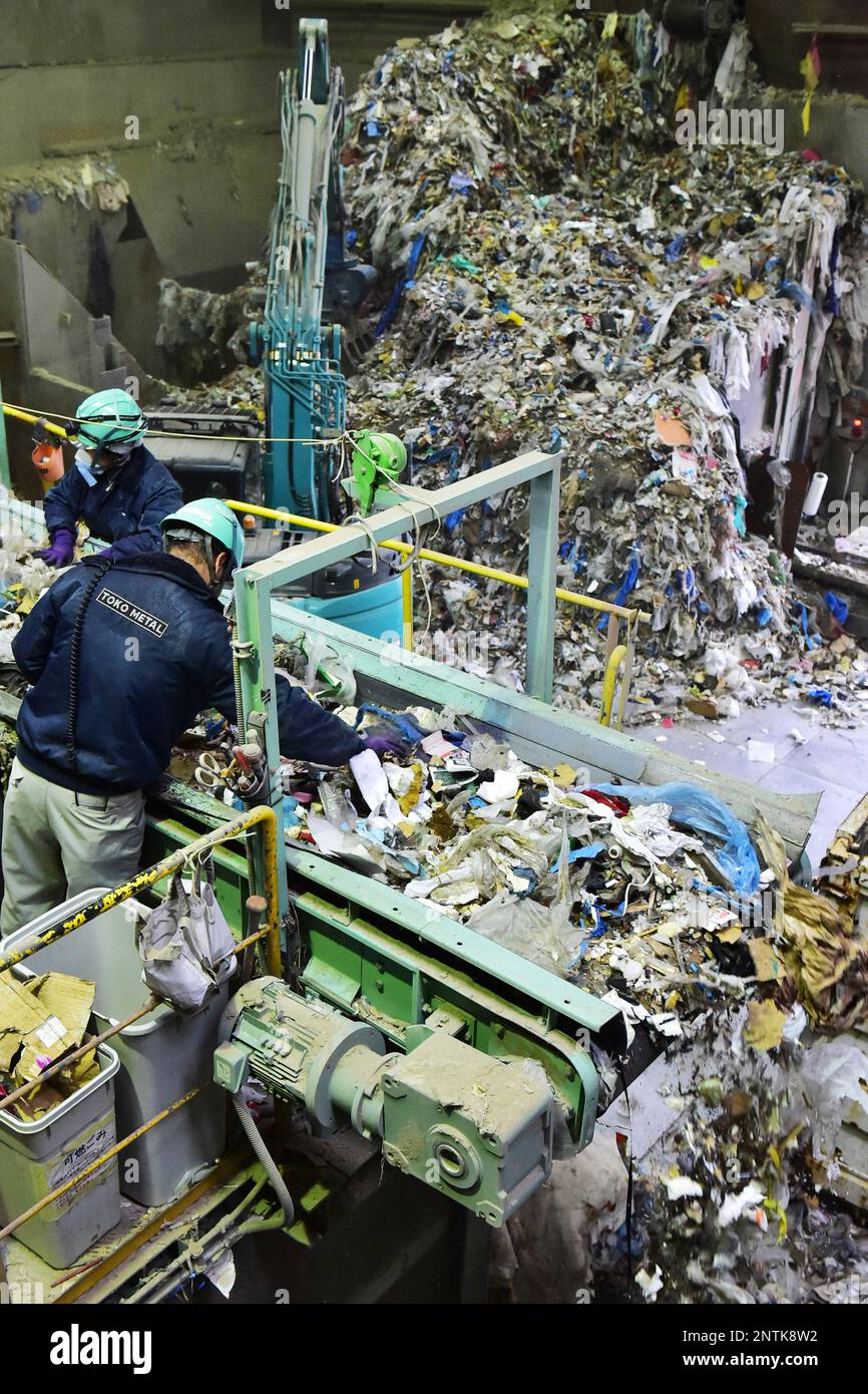 Workers of industrial waste company sort out plastic trashes for disposal in Ota Ward, Tokyo on