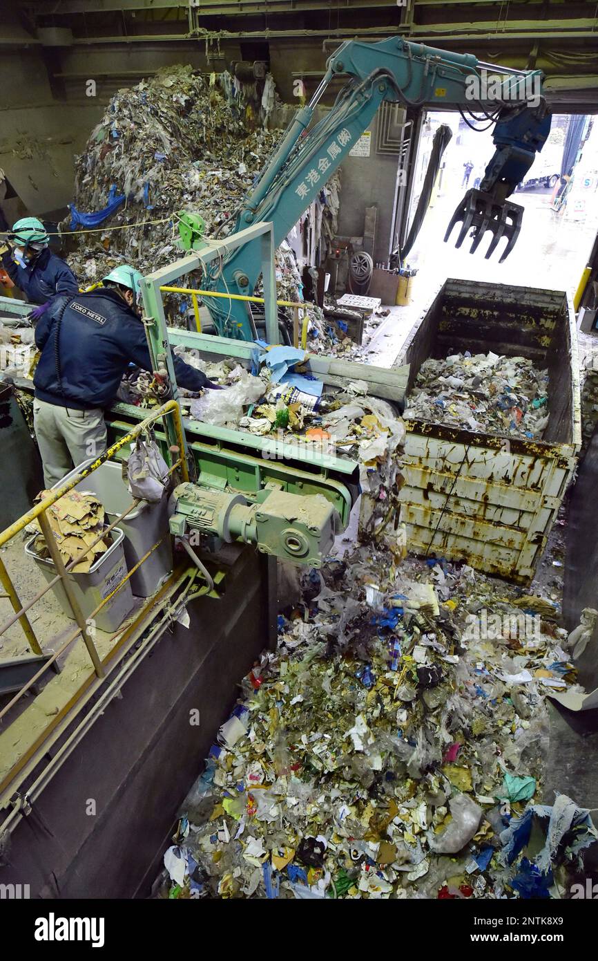 Workers of industrial waste company sort out plastic trashes for disposal in Ota Ward, Tokyo on