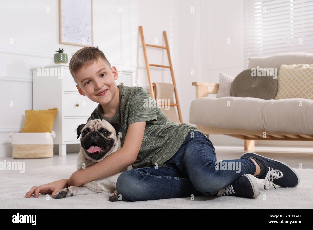 Boy with his cute pug in living room. Space for text Stock Photo - Alamy