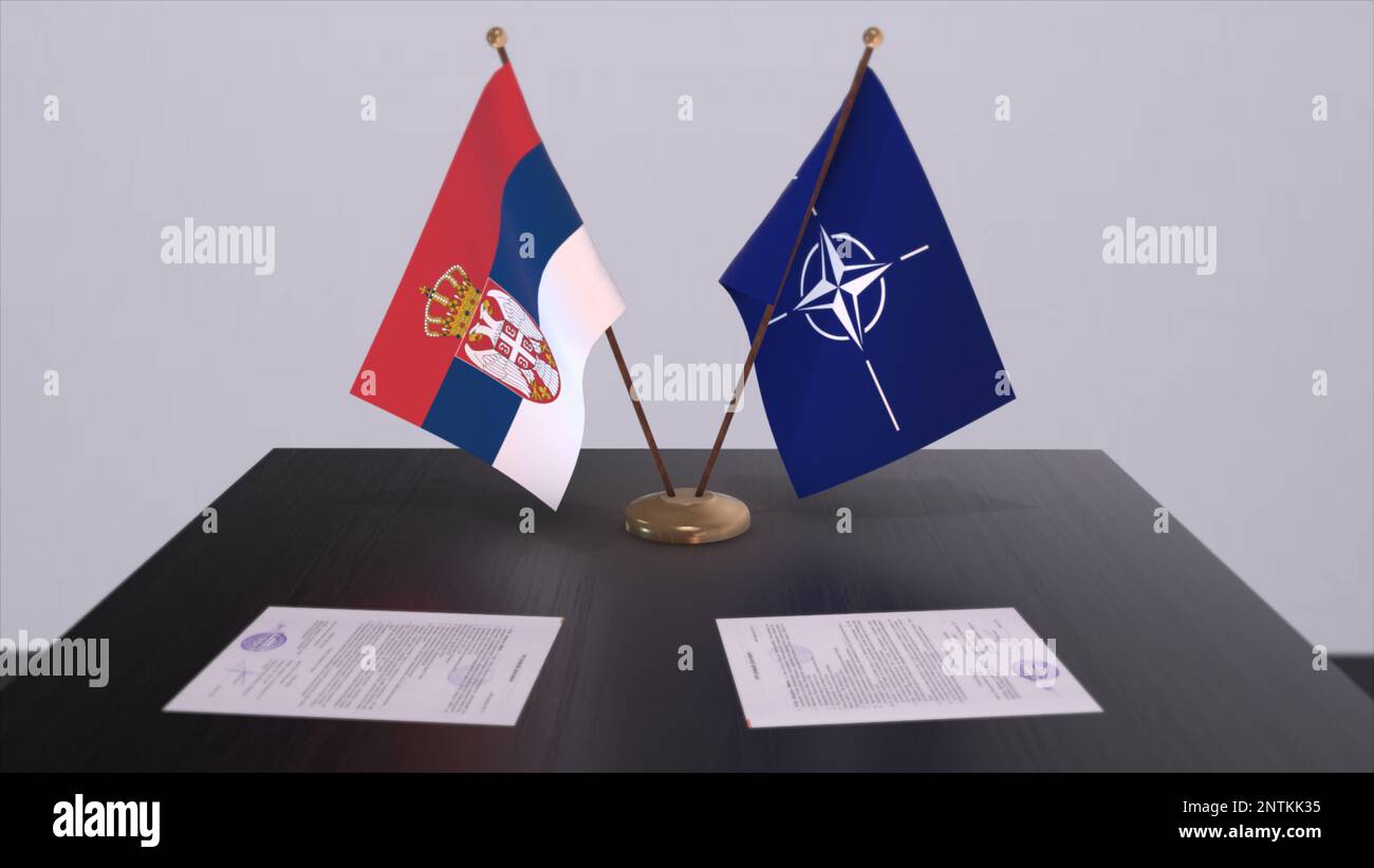 London, UK - 15 February 2023: Serbia country national flag and NATO flag. Politics and diplomacy illustration, Illustrative Editorial. Stock Photo