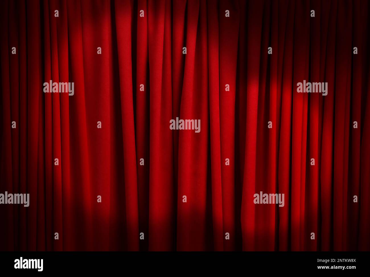 Spotlights illuminating closed red stage curtains. Start of performance Stock Photo