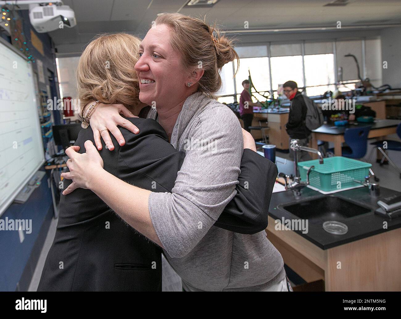 Platt High School teacher Jill Pomposi, right, hugs Dr. Dale 