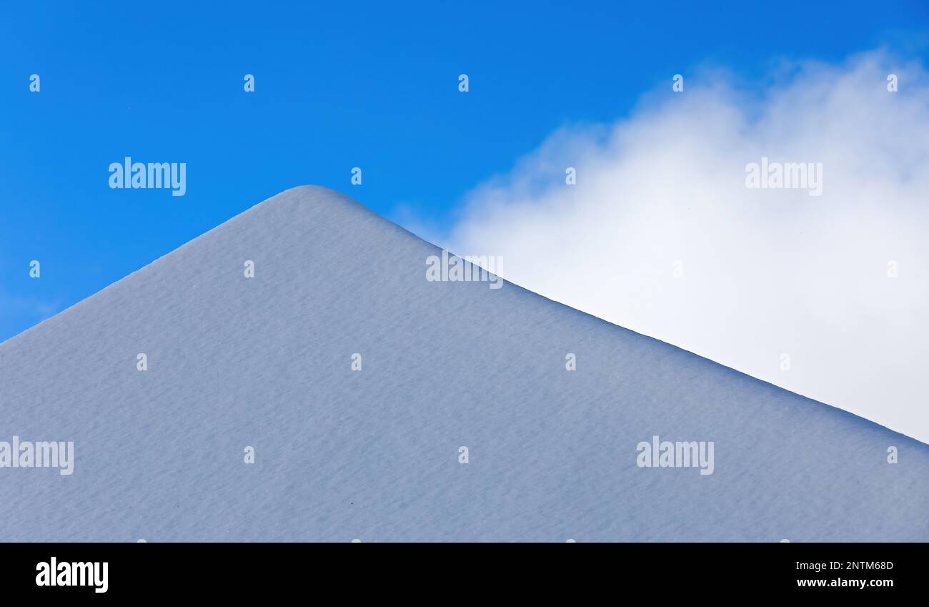Snowy roof top against the winter sky Stock Photo