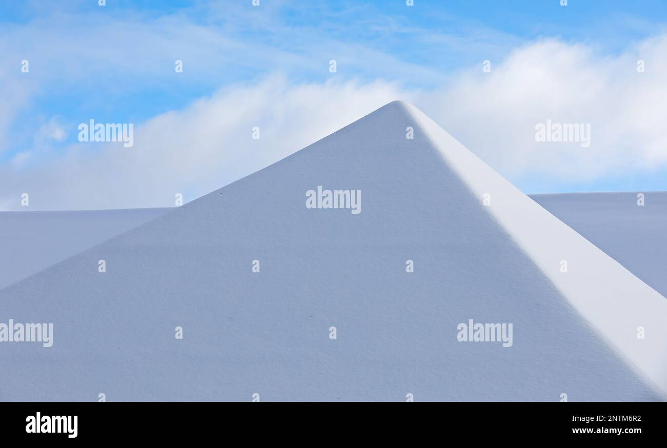 Snowy roof top against the winter sky Stock Photo