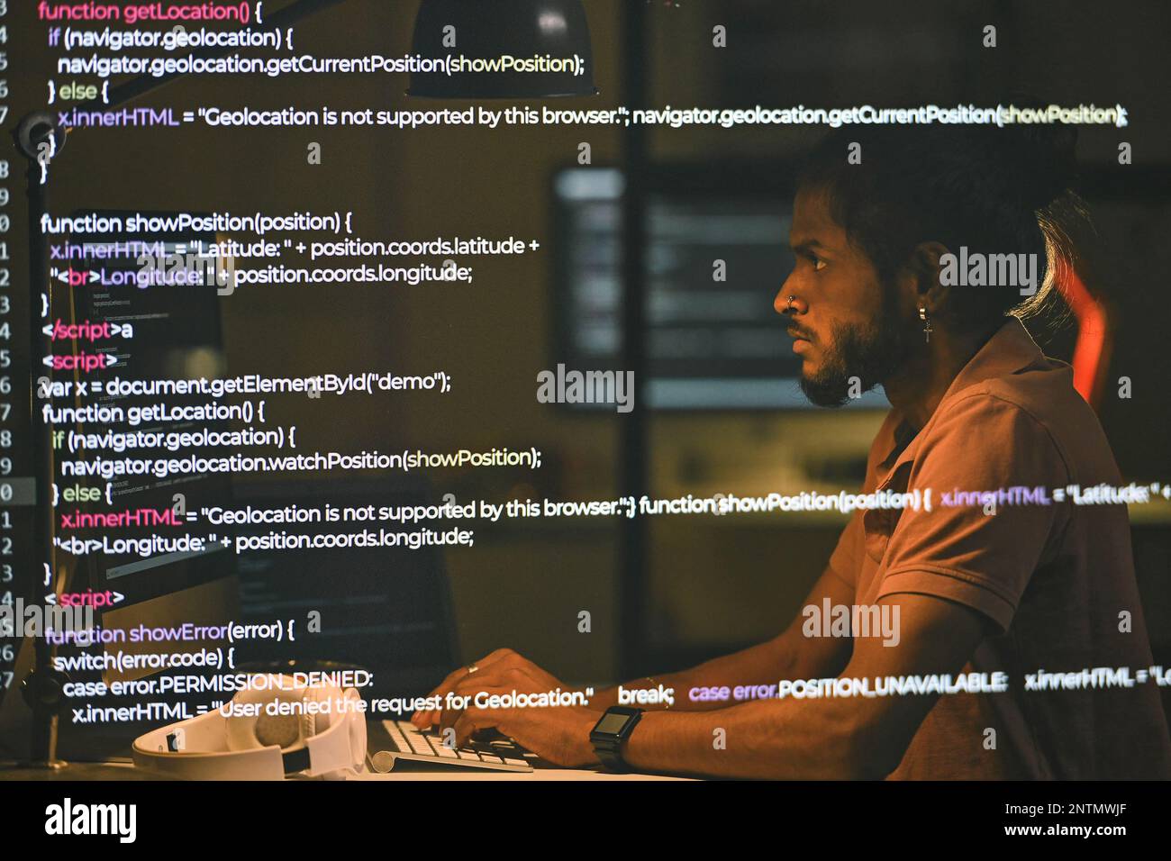 Serious programmer working with security codes on computer sitting at ...