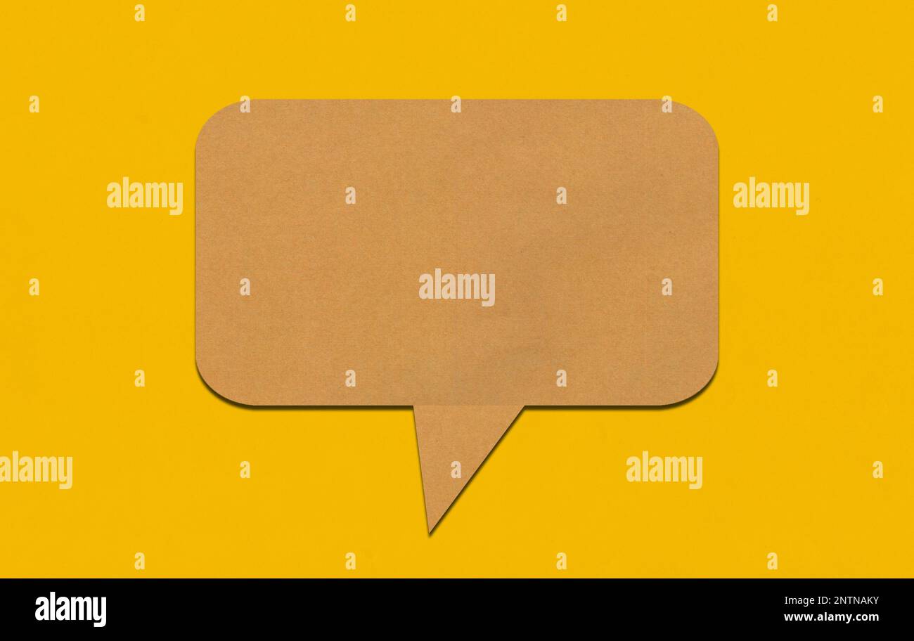 Brown paper speech bubble on yellow paper background. Paper blank of ...