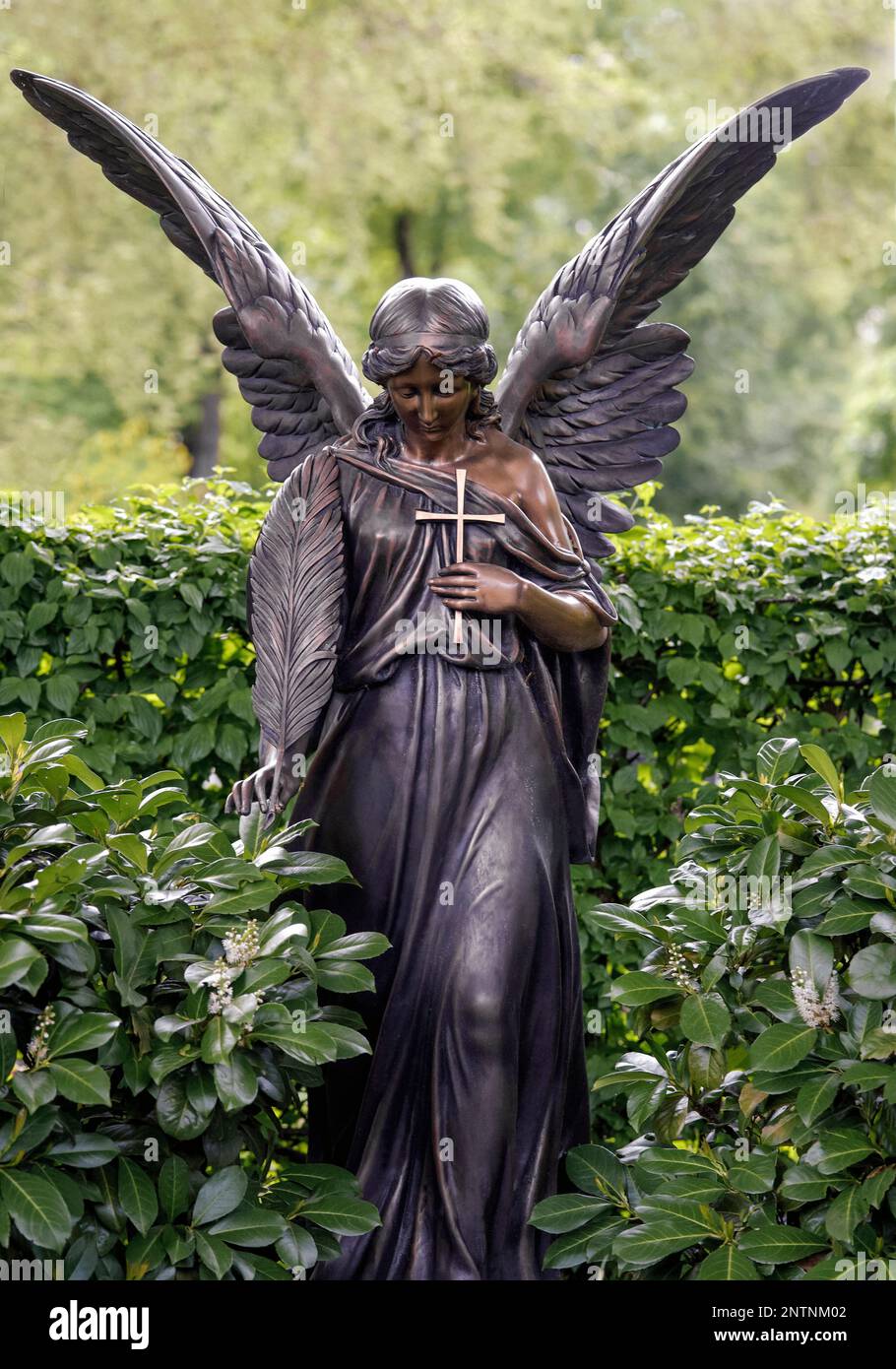 Bronze grave angel with cross and eather Stock Photo