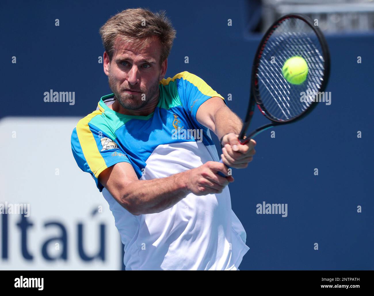 March 20, 2019: Peter Gojowczyk, of Germany, plays a backhand against  Federico Delbonis, of Argentina, at the 2019 Miami Open Presented by Itau  professional tennis tournament, played at Hardrock Stadium in Miami