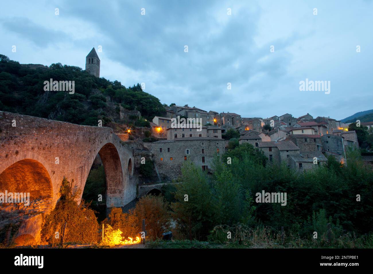 France, Languedoc-Roussilon, Olargues, Pont du Diable bridge in the pretty hill top village of Olargues in the Black Mountains. Stock Photo
