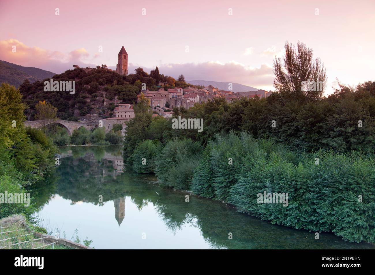 France, Languedoc-Roussilon, Olargues, Pont du Diable bridge and the pretty hill top village of Olargues in the Black Mountains. Stock Photo