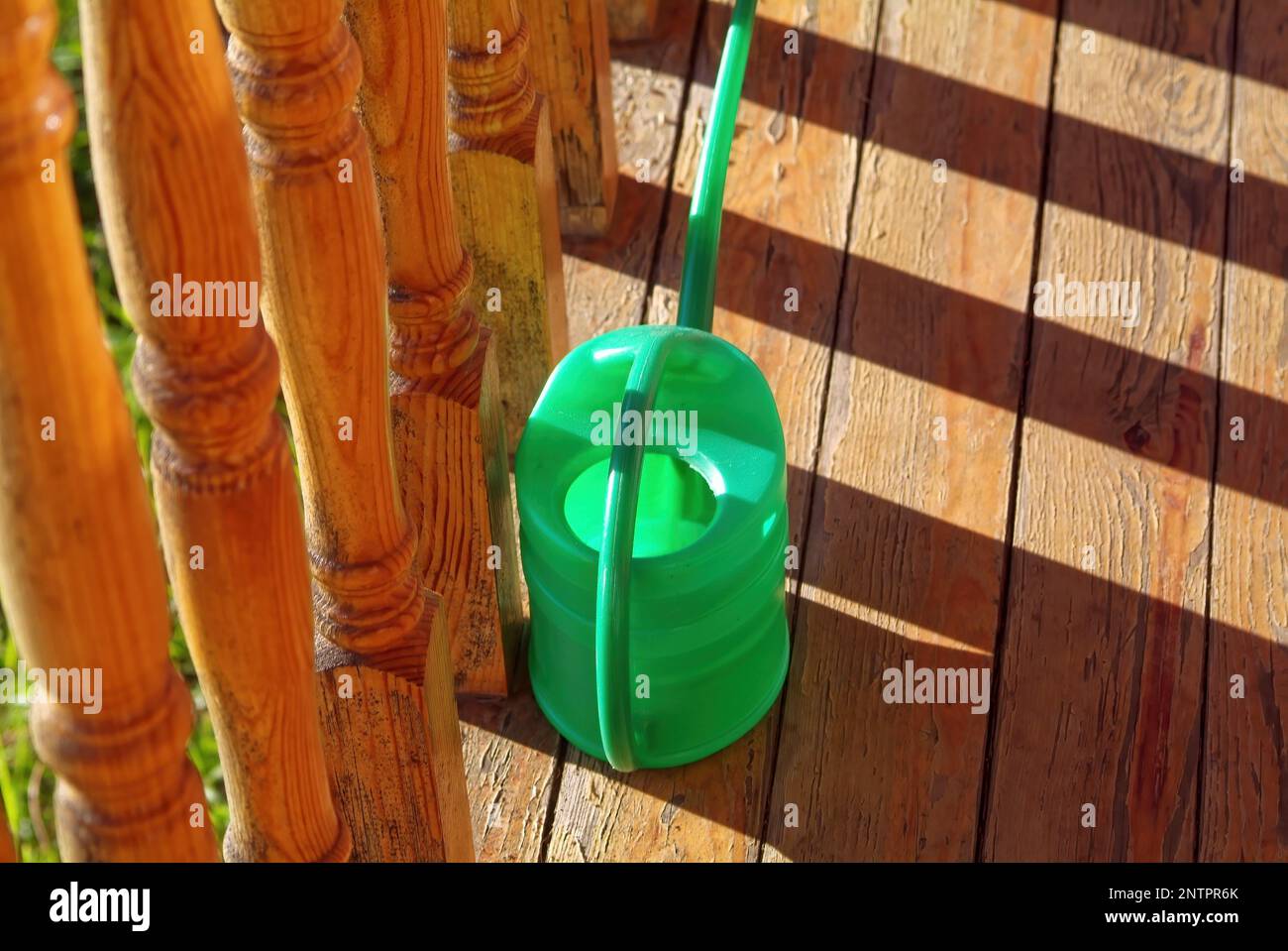 plastic watering cans in the village, in the spring Stock Photo
