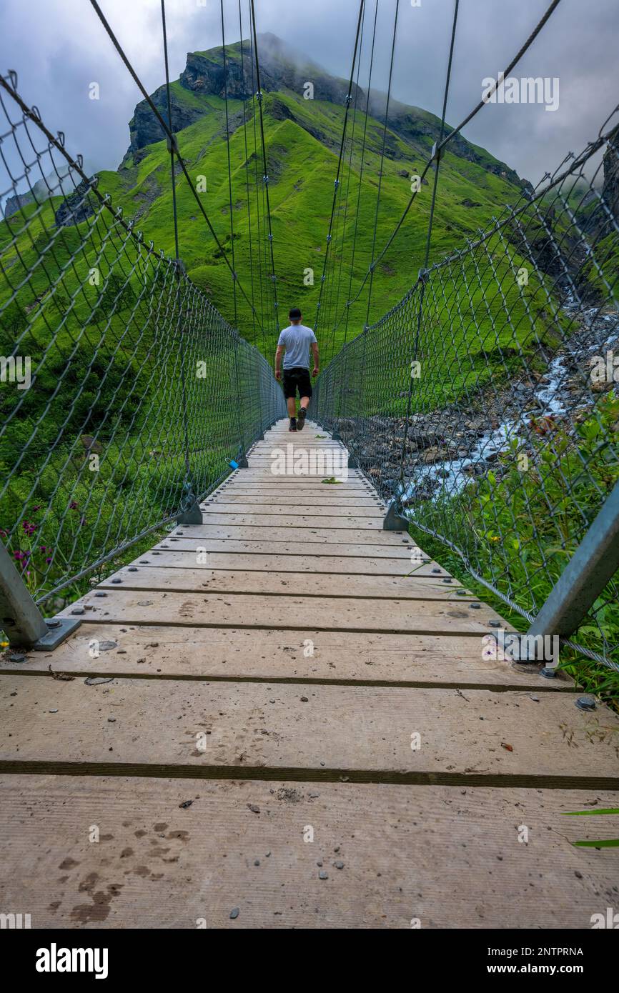 Man standing on suspension bridge hi-res stock photography and images ...