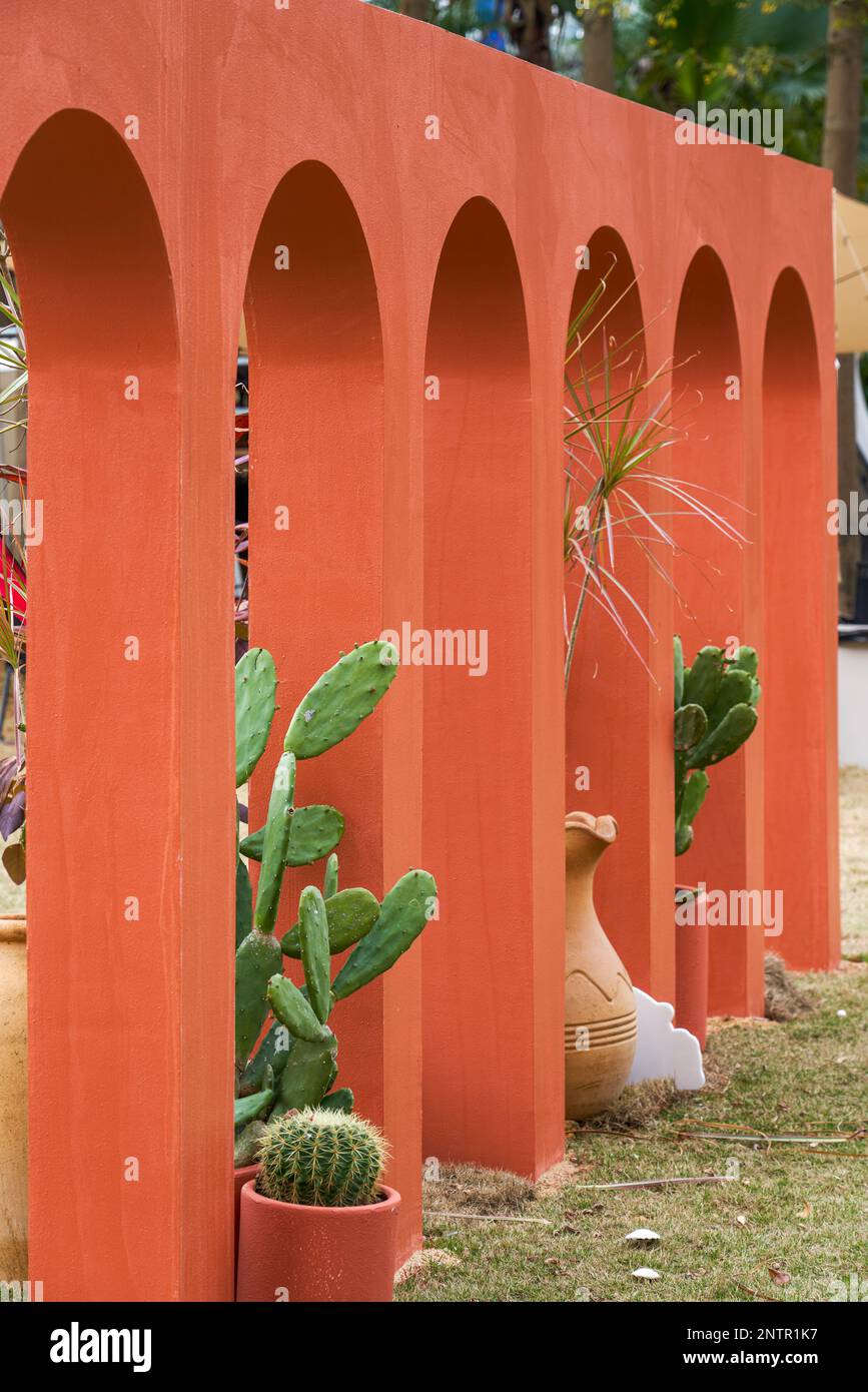Decorative building with red arches placed in the park Stock Photo Alamy