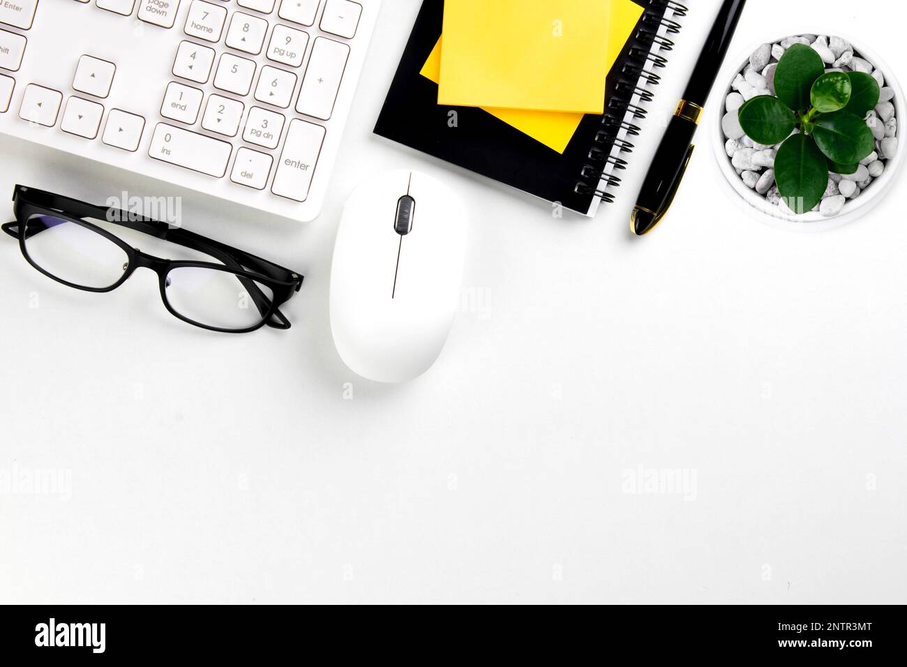 Top view of modern white desk with other devices in office on white